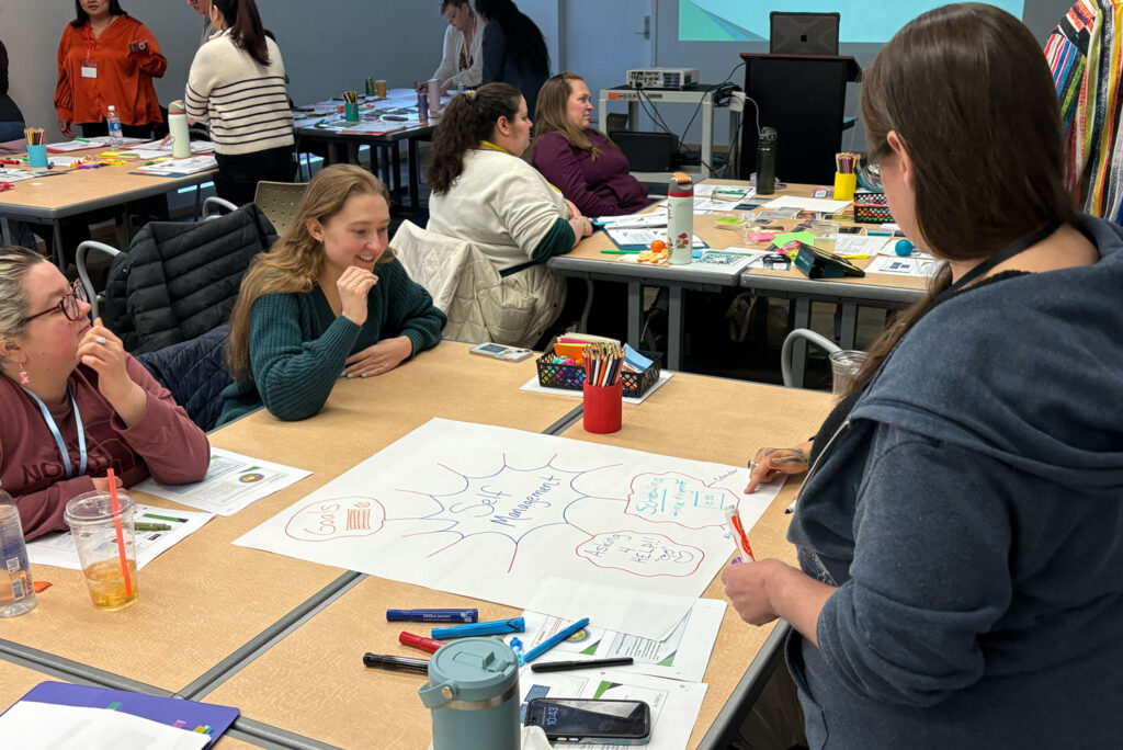 Youth-serving professionals working together at tables
